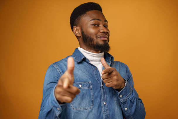Young african american man wearing casual clothes pointing at you against yellow background - Zdjęcie, obraz