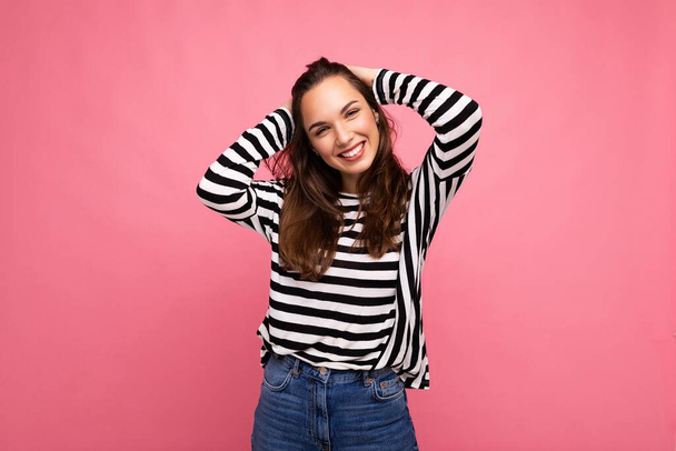 Portrait of positive cheerful fashionable woman in casual clothes isolated on pink background with copy space - Valokuva, kuva