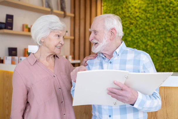 Elderly couple choosing procedures in a spa center - Photo, Image