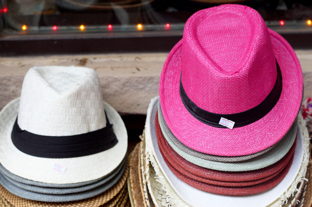 hoeden zijn gestapeld voor verkoop op de markt - Foto, afbeelding