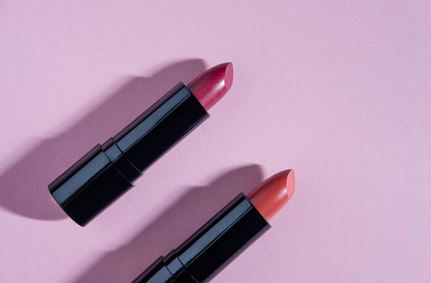Set of lipsticks on light pink background. General cosmetic products illustration. - Fotografie, Obrázek