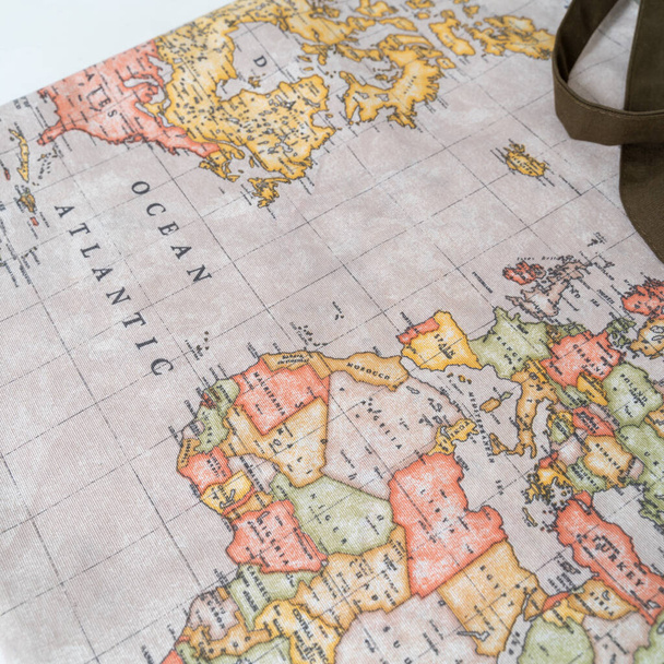 A closeup shot of a tote bag with a colorful printed world map - Fotoğraf, Görsel