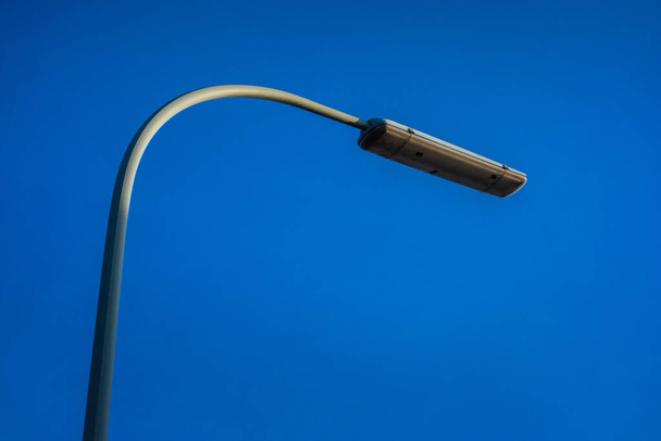 A low angle shot of a streetlight on a blue background - Фото, изображение