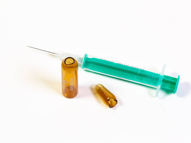 a syringe and a broken ampule on white background (copy space) - Photo, Image