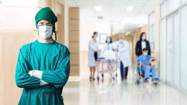 Surgeon man doctor we are mask and grove protection coronavirus.  Team Medical personnel and patients for discussion at hospital clinic room background.   Teamwork medical doctor working clinical treatment and protection virus. - 写真・画像