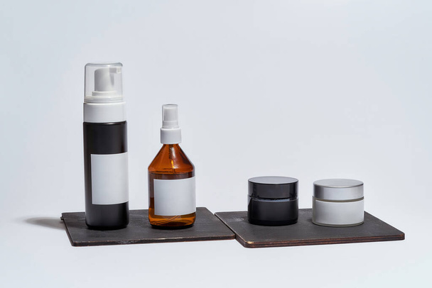 Set of cosmetological bottles with empty labels - 写真・画像