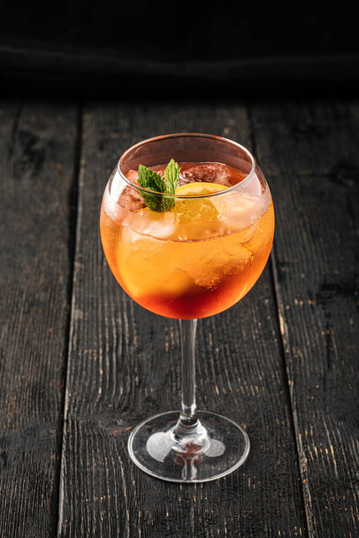 Side view on a glass of aperole spritz cocktail - Fotó, kép