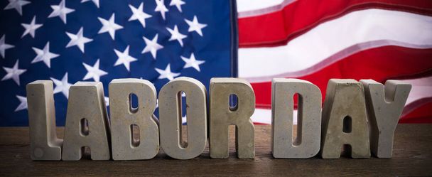 Happy Labor Day banner. USA flag and letters on rustic wooden background. - Foto, imagen
