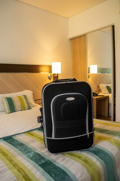 travel suitcase on a hotel bed - Photo, Image
