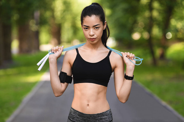 Motivated Fit Asian Woman Posing With Skipping Rope Outdoors, Training In Park - Photo, Image