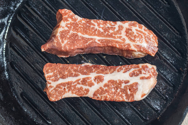 Marbled beef steak on a grill pan. - Photo, Image
