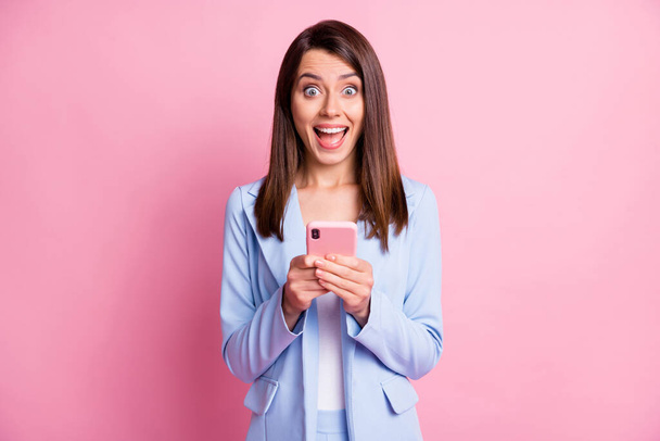 Photo of young happy smile blogger girl use cellphone excited surprised news like wear jacket isolated over pastel color background - Fotografie, Obrázek