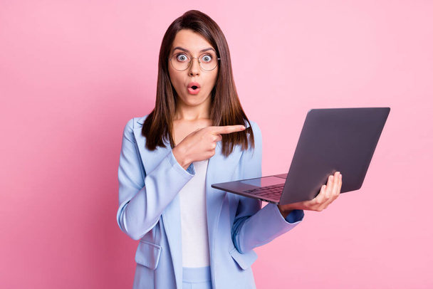 Photo of young woman excited amazed point index finger laptop ad promo choice choose isolated over pastel color background - Photo, Image