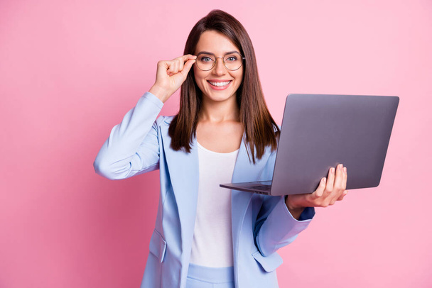 Photo of young business woman happy smile confident hold laptop hand touch glasses isolated over pink color background - Photo, Image