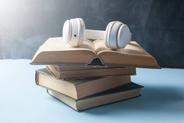 audiobook concept. books and headphones on the table - Fotó, kép