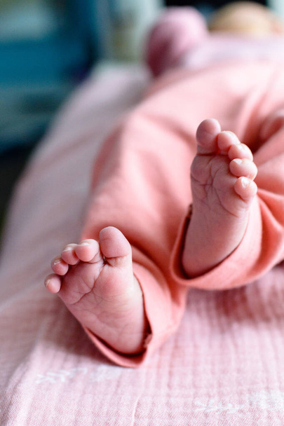 Cute newborn baby feet with little toes in a selective focus - Photo, Image