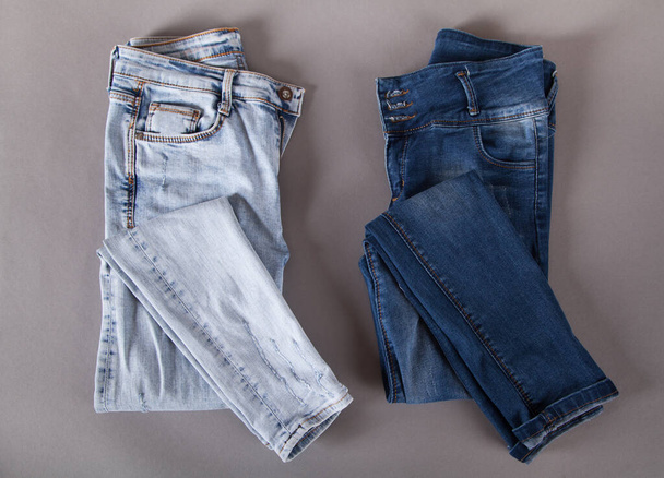 Fashion different jeans on gray background.  - 写真・画像