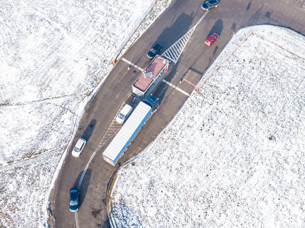 Aerial view of the logistics park with warehouse, loading hub and many semi trucks with cargo trailers standing at the ramps for load/unload goods a - Photo, Image