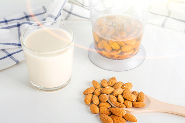 Step by step recipe. Cooking nuts vegetable milk. Step 3 cooked  almonds milk in glass. Homemade food concept. Plant based organic veggie milk, lactose free - Fotoğraf, Görsel