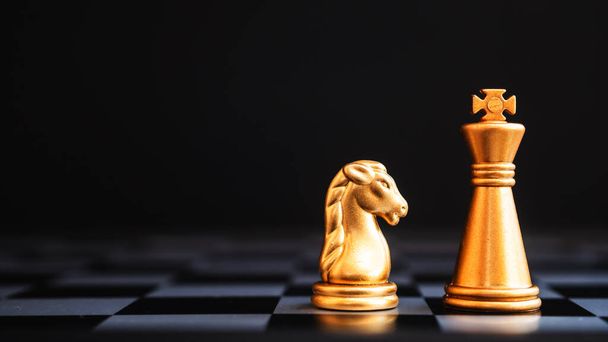 Chess board game staying against full set of chess pieces. Strategy, Planning and Decision business concept - Photo, Image