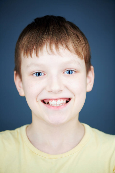 happy smiling boy on blue background - Фото, изображение