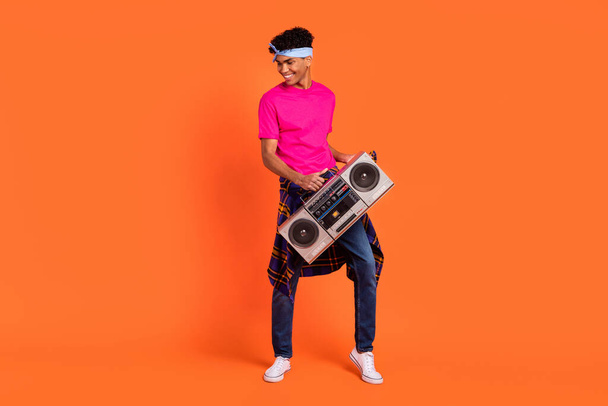 Full length body size photo funky guy dancing on holiday keeping boom box smiling isolated bright orange color background - Fotoğraf, Görsel