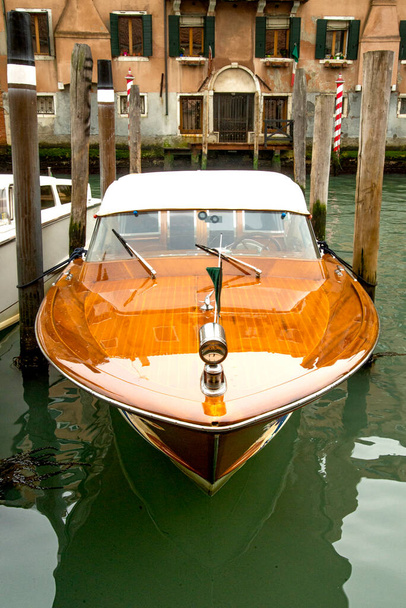 прекрасний старий блискучий дерев'яний моторний човен припаркований на каналах Венеції. - Фото, зображення