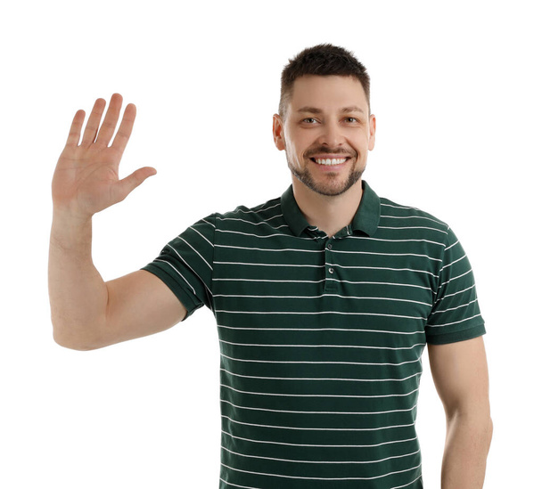 Cheerful man waving to say hello on white background - Фото, изображение