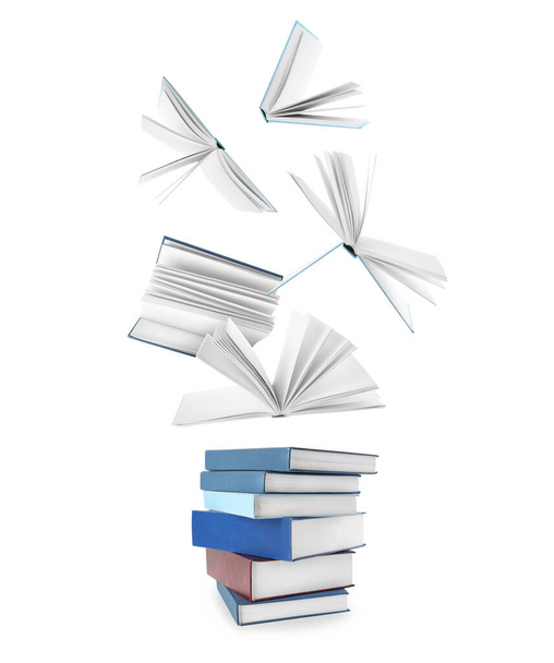Stacked and flying books on white background, collage - Фото, изображение