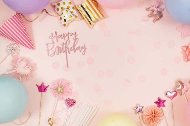 Background for happy birthday celebration or party. Group of colored balloons, confetti, candles, ribbons on pastel pink background. Mockup with copy space, a place for text - Foto, Bild