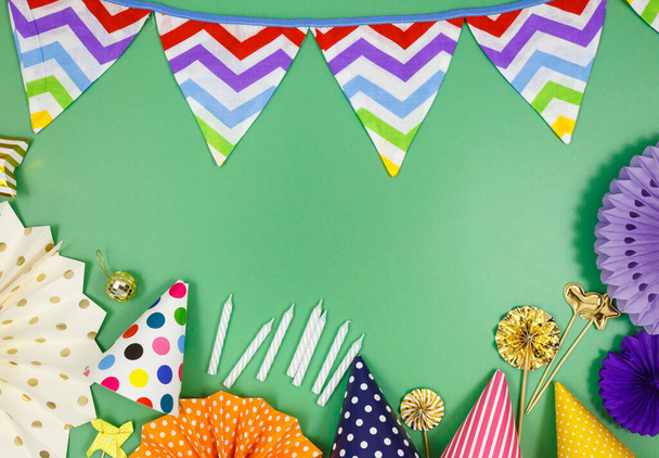Background for happy birthday celebration or party. Group of colored balloons, confetti, candles, ribbons on green pastel background. Mock up with copy space, a place for text - Fotoğraf, Görsel