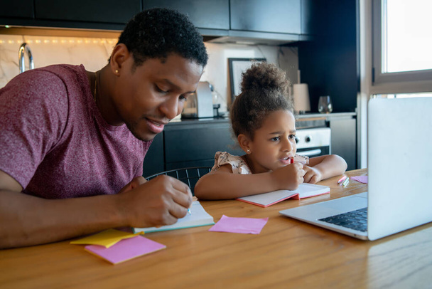 A father helping his daughter with homeschool. - Foto, Imagem