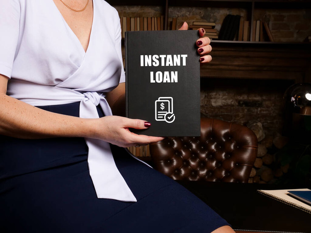 Young woman holding a blank card in hands. Conceptual photo about INSTANT LOAN with written text. - Photo, Image