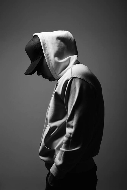 Young Man in Hat and Hood. Boy in a hooded sweatshirt Black and white portrait - Φωτογραφία, εικόνα