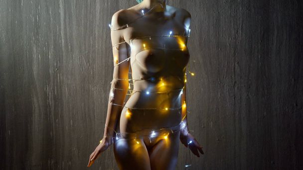 Naked young slim girl with Christmas lights - Photo, Image