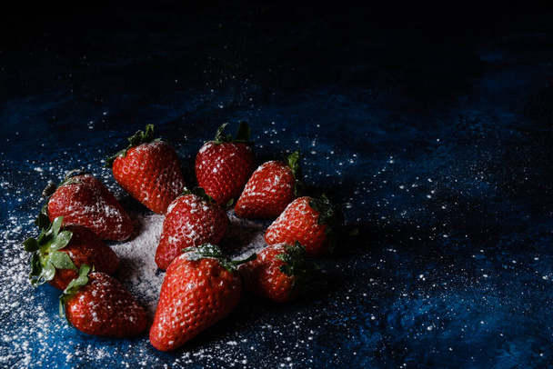 A closeup shot of delicious strawberries with sugar and powder - 写真・画像
