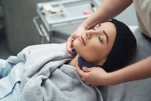Пациентка получает массаж шеи от профессионального косметика - Фото, изображение