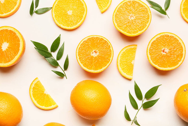Verse sinaasappels met groene bladeren op witte achtergrond - Foto, afbeelding