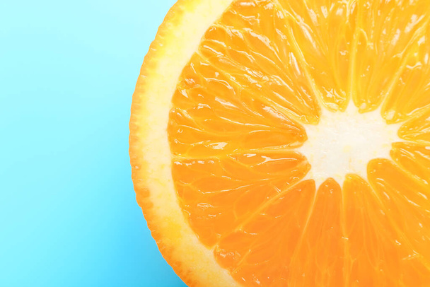 Piece of fresh orange fruit on color background, closeup - Photo, Image