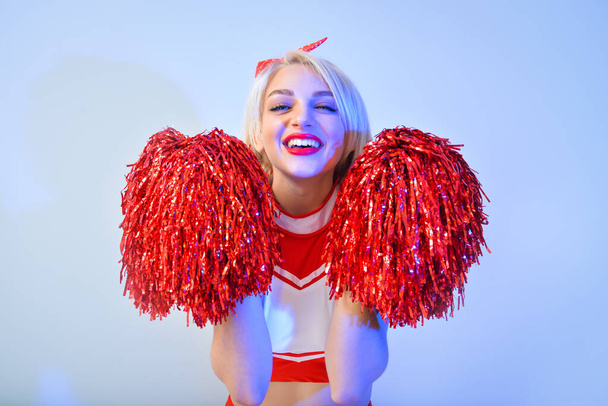 Beautiful cheerleader on color background - Photo, Image