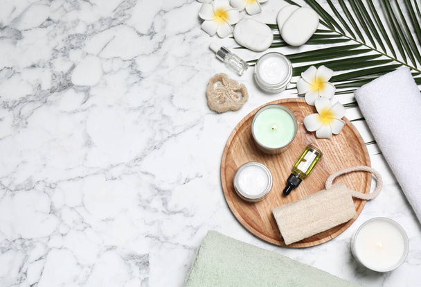 Flat lay composition with spa essentials on white marble background. Space for text - Foto, afbeelding