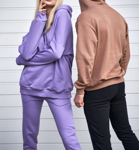 Two persons is standing in casual streetwear without logo. Design template of sport clothing line - Photo, image