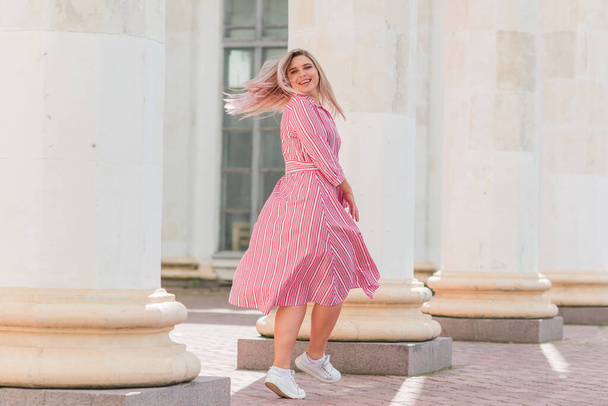 Happy smiling fashionable plus size young woman in modern city life. Life of xl lady. Concept of positive lifestyle. Pretty stylish girl at city center - Zdjęcie, obraz