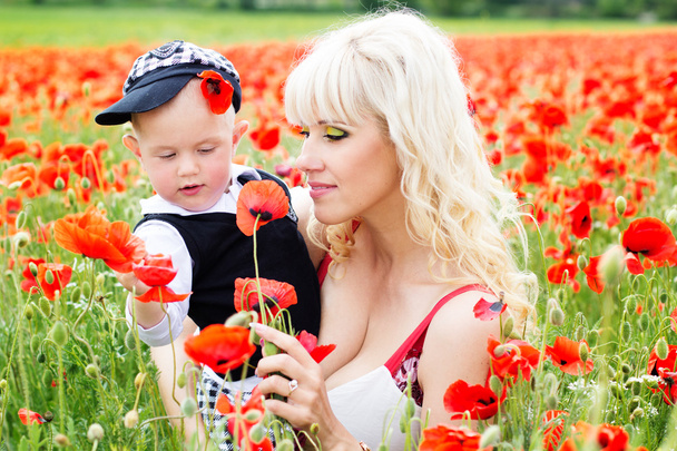 Happy mother and son on the poppies field - Φωτογραφία, εικόνα