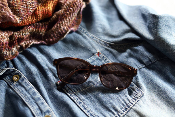 Denim shirt, knit snood and sunglasses, autumn outfit fashion - Photo, Image
