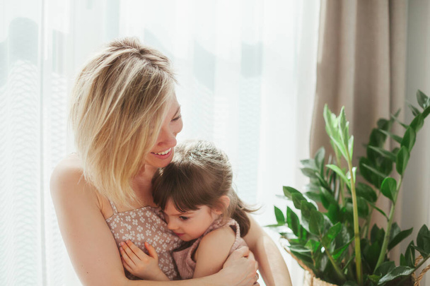 Woman hugging her cute little girl. Happy Mother's day! Family holiday and togetherness. - Photo, Image