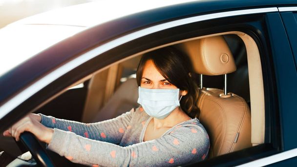 Woman in the medical mask in car. coronavirus, disease, infection, quarantine, covid-19 - Foto, Imagem