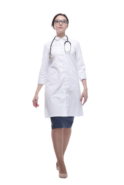 confident female doctor with a stethoscope striding forward. - Φωτογραφία, εικόνα