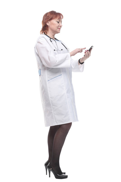 in full growth. medical woman with a smartphone. - Fotó, kép