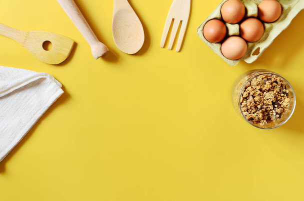 Flat lay with different kitchen and cooking utensils on yellow background. Culinary blog, recipe template, online cooking courses. Healthy food concept. Copy space, top view.  - Photo, Image